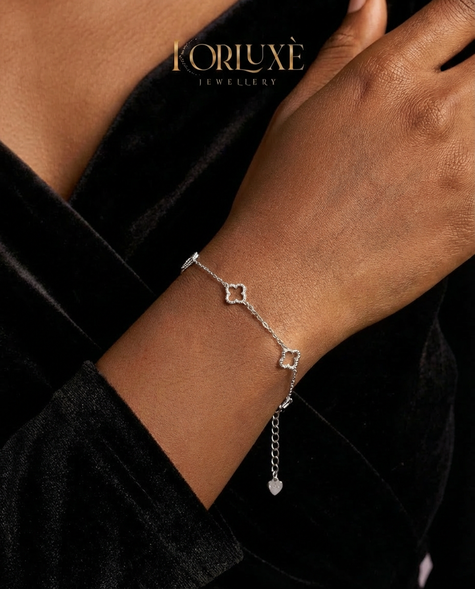 KorLuxé Silver Charm Bracelet worn on hand, featuring silver charms and an adjustable chain for a chic minimalist look.