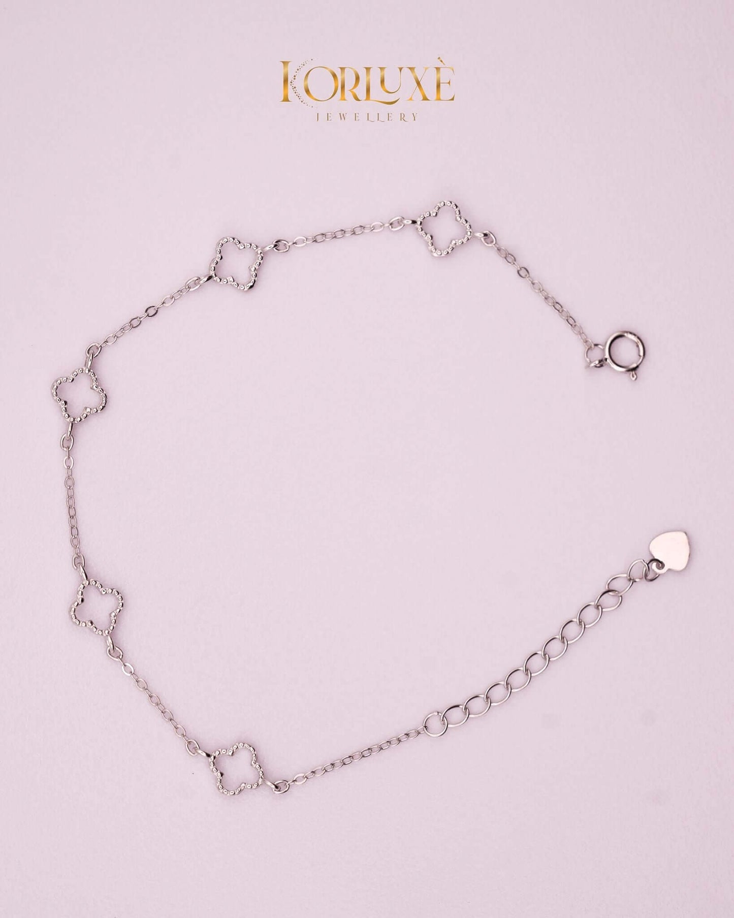 KorLuxé Silver Charm Bracelet on a light background, showcasing elegant silver charms and adjustable chain.