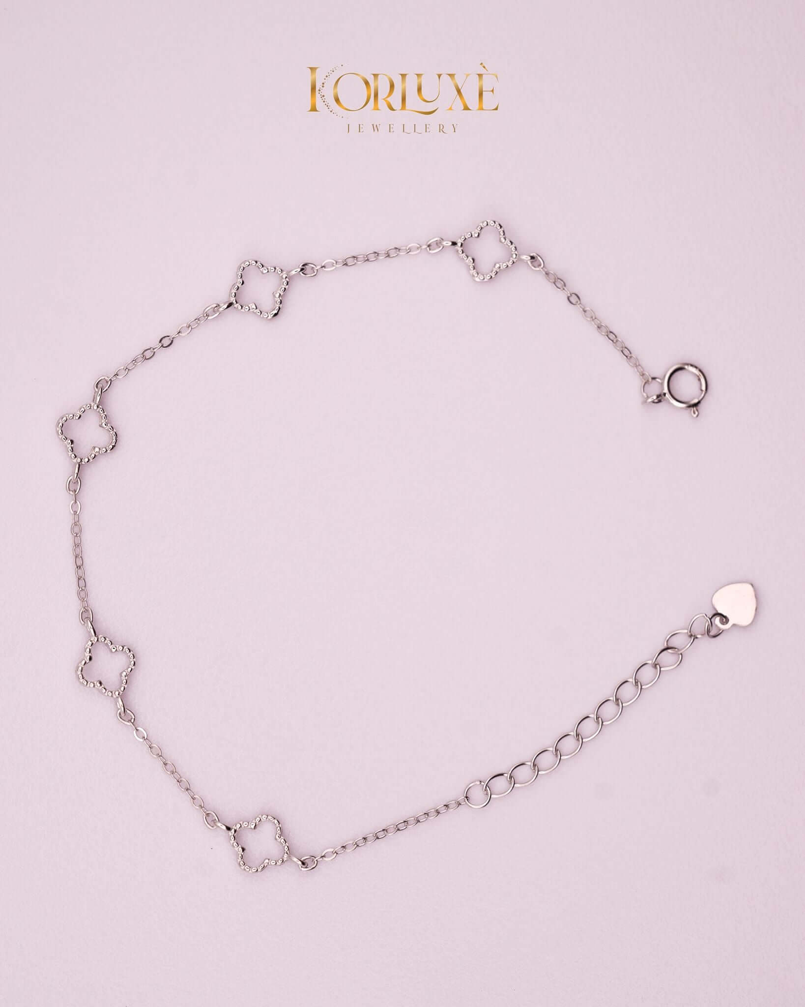 KorLuxé Silver Charm Bracelet on a light background, showcasing elegant silver charms and adjustable chain.