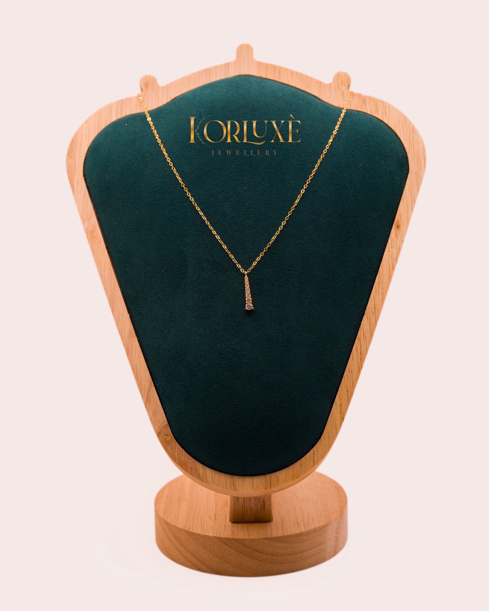 Gold-Plated Crystal Necklace displayed on a green velvet jewelry stand by KorLuxé.
