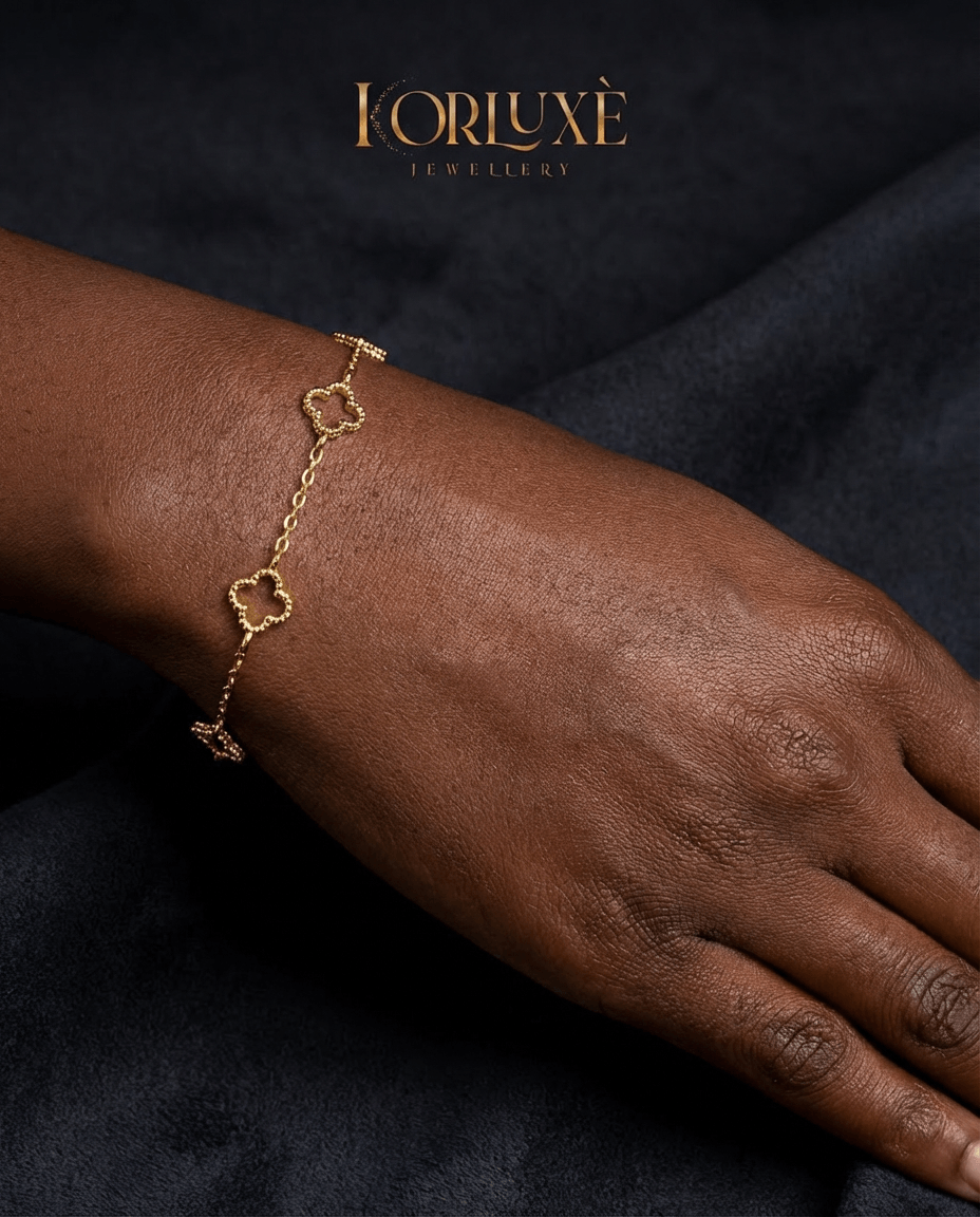 Lucky clover charm bracelet showcasing a gold chain on a model's wrist, symbolizing elegance and luck.