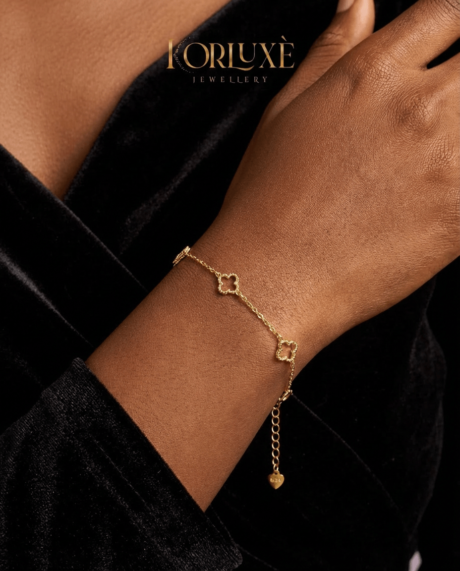 Lucky clover charm bracelet worn on a wrist, showcasing its minimalist gold design and elegant clover charms.